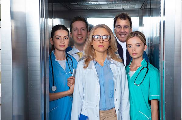 Doctors in an elevator at a hospital covered with disability insurance for physicians