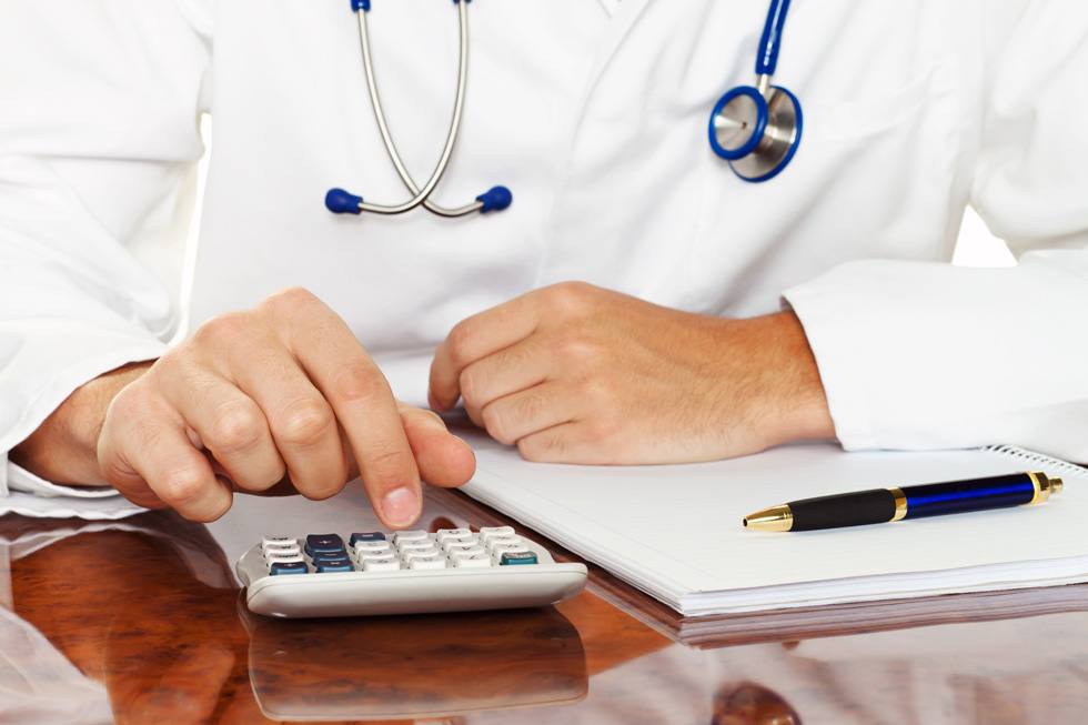 Doctor with a calculator planning Disability Insurance in Southern California