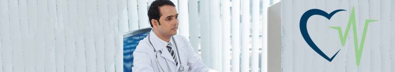 doctor checking computer for life insurance coverage